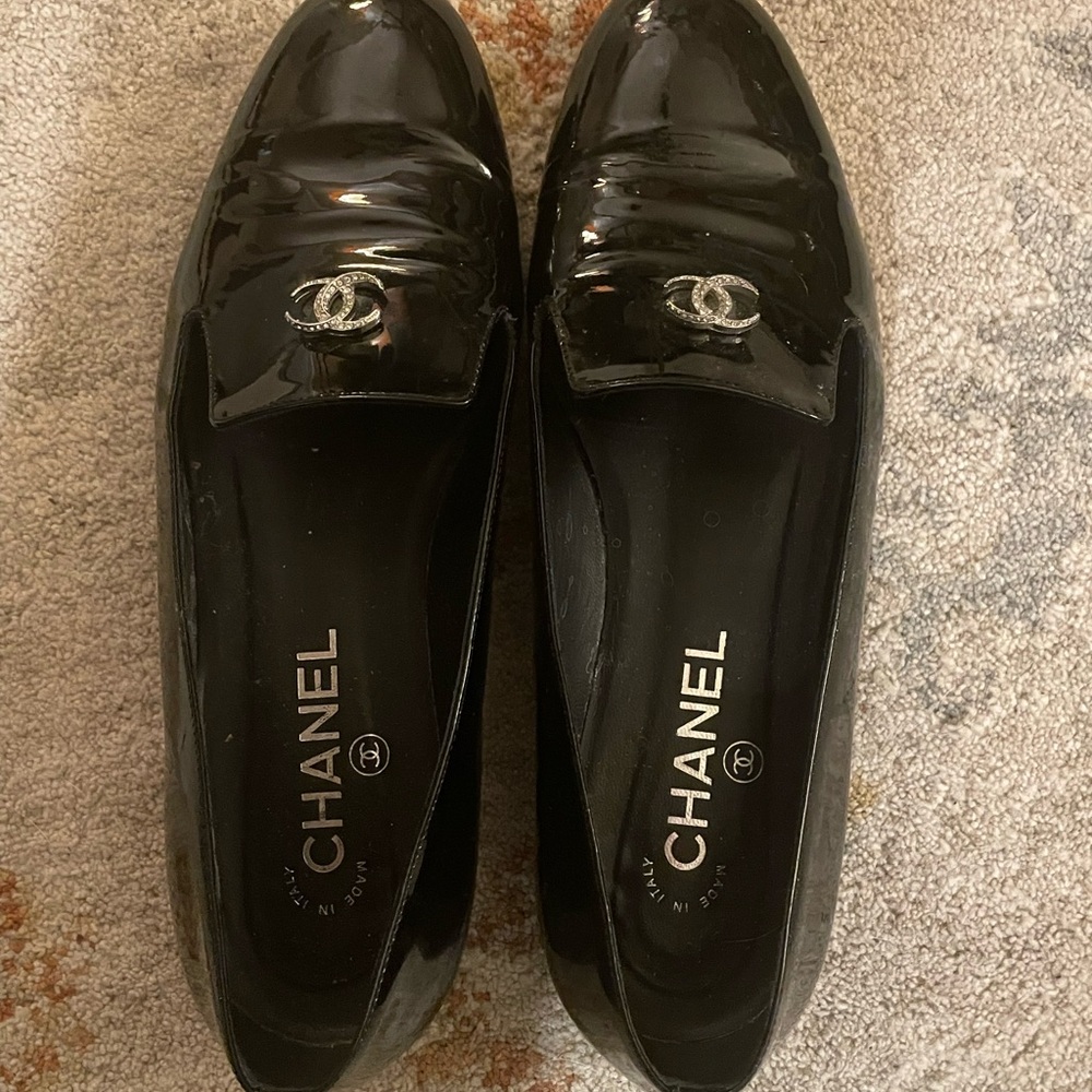 CHANEL Glossy Black Patent Loafers with Silver Logo